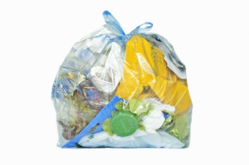 Business waste containers awaiting collection on a street