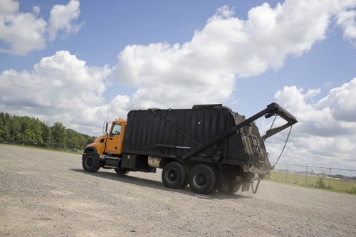 Workers sorting separated commercial recycling at borough facility